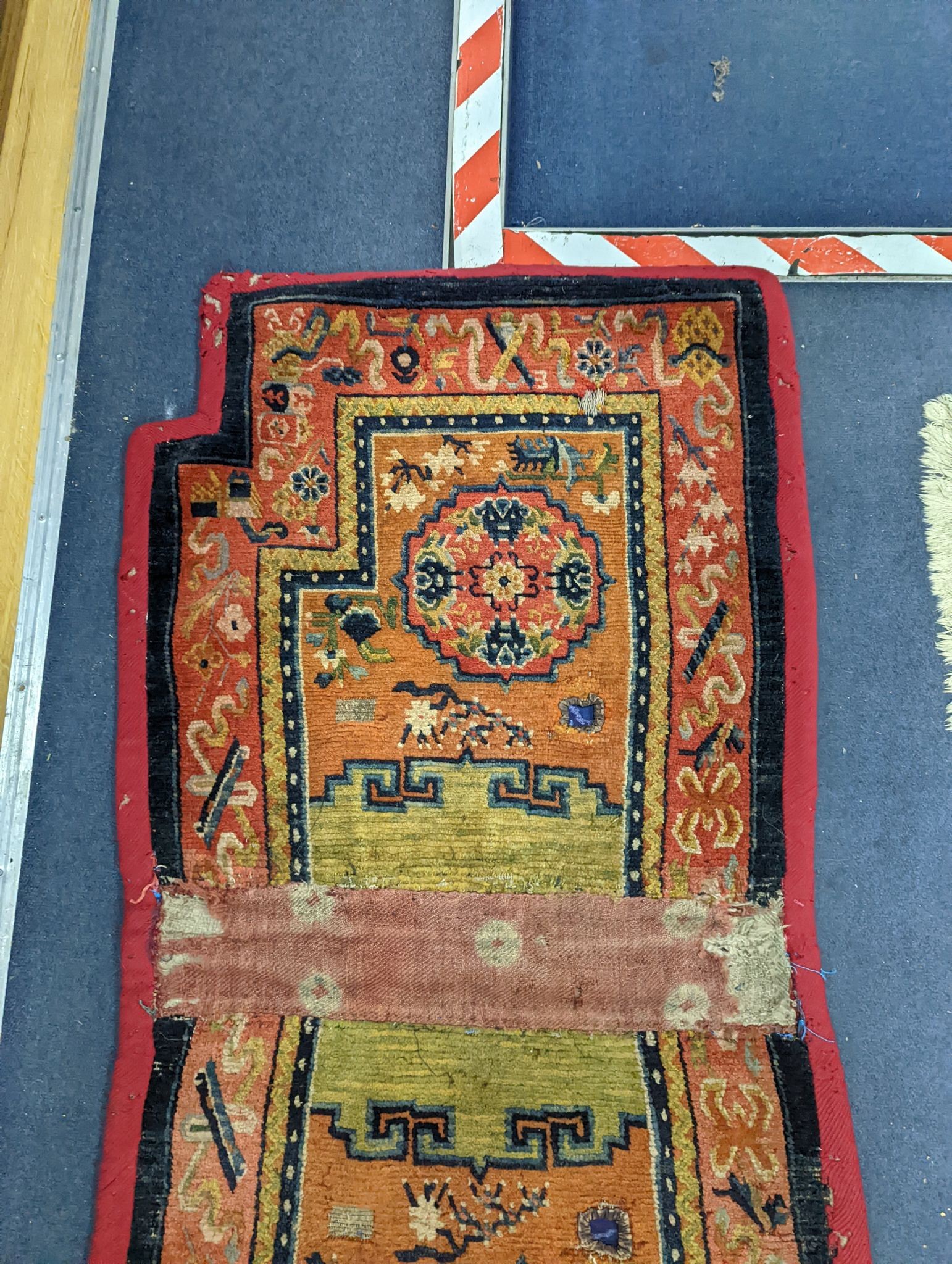 An antique Tibetan saddle cover, 132 x 64cm